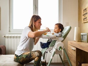 a person feeding a baby