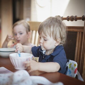 a couple of children eating