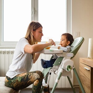 a person feeding a baby