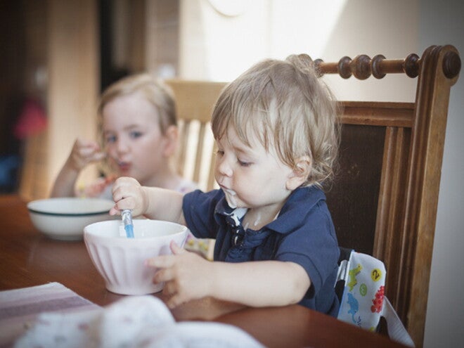 a couple of children eating